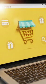 Laptop screen displays yellow e-commerce webpage with 3D shopping cart, awning, gift icons, symbolizing online shopping, sales, and digital marketplace