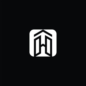 A bold, geometric logo design featuring a stylized letter “H” within a square frame, resembling a modern architectural structure or abstract building