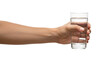 © adfern364 - Holding clear glass with water in hand against white background