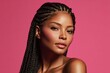 © Surachetsh - A confident beauty with braided hair and luminous pink makeup poses effortlessly against a serene pastel background.