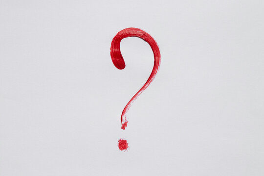 Watercolor question mark red on white background as a question symbol drawn with a brush in red paint, handwritten