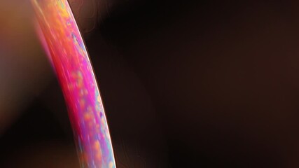 Fototapete - 	
Bright multicoloured liquid surface on black background, interference pattern, one colourful curved line