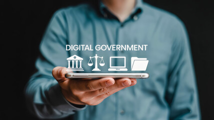 A person holds a smartphone displaying icons representing digital government services, including a building, scales of justice, a laptop, and a folder