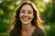 © Rgfx - Happy Young Woman Smiling Outdoors with Soft Green Bokeh Background