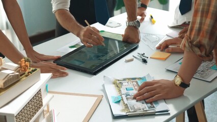 Poster - Close up of smart business team hand working together to plan design while looking at project plan from tablet and discussing about blueprint and building construction at meeting table. Alimentation.