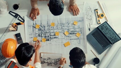Poster - Top down aerial view of smart architect engineer team pointing and discussing about building construction. Group of diverse people working together to plan and design by using blueprint. Alimentation.