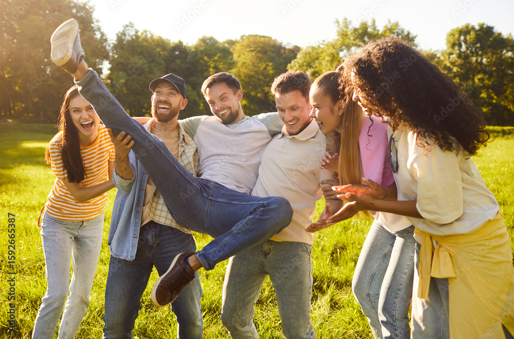 Overjoyed friends having fun and laughing while posing in park, have ...