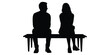 © Welcome - Man and woman silhouetted sitting on a bench illustrate disconnection, separation, or perhaps reflection in solitude.