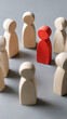 © Rakib - Distinctive red figure among pale wooden figures people