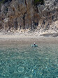 © Elena - Child Swimming in Crystal Clear Water by Rocky Sardinian Coast, Cala luna