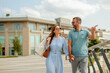 © BGStock72 - Enjoying a sunny afternoon stroll along the waterfront with laughter and discovery in a vibrant city setting