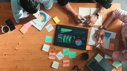 Poster - Top aerial view of diverse team writing colorful sticky notes to brainstorm marketing idea while looking at financial chart. Multicultural smart business people taking a note about plan. Convocation.