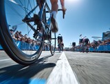 Cyclist Wheels and Seat in Focus on Race Track with Motion Blur and Cheering Crowd Under Blue Sky