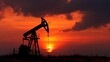 © Harry - Dramatic silhouette of oil pump against intense sunset showing extraction during golden hour with beautiful gradient colors.