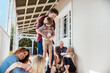 © Marko Geber - Multigenerational caucasian family being playful and having fun on a balcony of their house