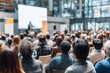 © Rifqi - Large audience listens to speaker at conference, concept for business seminar, executive training and corporate presentation with a group of vice president level management staff
