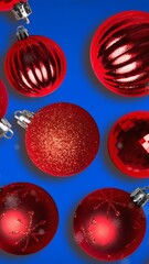Poster - Animation of snow falling over christmas bauble decorations on blue background