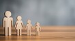 © PhotoHub - Photo of wooden figures representing a family stand together on a wooden surface