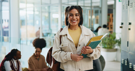Girl, college student and portrait with books at campus with pride, education and smile for scholarship. Woman, happy and confidence in hallway, learning and development with knowledge at university