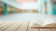 © Passakorn - An open book lies on a wooden surface with a blurred bright indoor background, evoking a calm and studious atmosphere.