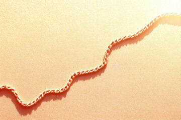 Aufkleber - Soft abstract textile thread path at edges, calm and warm atmosphere, orange twisted string on textured fabric background, gentle sunlight, minimalistic and peaceful mood