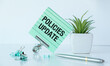 © Pawel - A green piece of paper with the word Policies Update written on it