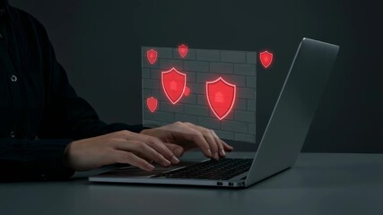 Poster - Person typing on laptop keyboard with digital red shield icons providing cyber security and data protection, footage.