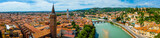 View of Ponte Pietra, Verona’s ancient Roman stone bridge crossing the Adige River under a clear sunny sky with historic buildings nearby