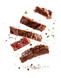 © Supanun - Flying Steak Slices: A culinary masterpiece of perfectly grilled steak slices, mid-air, evoking savory delight.
