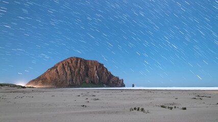 Wall Mural - morro rock star trails time lapse above pacific ocean astrophotography night sky time lapse in calif