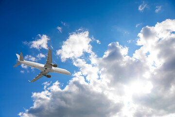 Wall Mural - airplane flying in beautiful blue sky with clouds