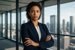 © Bijac - Confident diverse female entrepreneur in elegant navy blazer standing in modern glass office with city skyline view radiating success and leadership