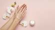 © Aquarine - Applying Cream to Hands with Orchid Flowers on Pink Background