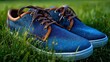 © Zarana  - Closeup of Blue Denim Sneakers with Brown Leather Detail on Grass.