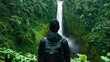 © Anousone - Person exploring a waterfall in a lush forest, adventurous, refreshing
