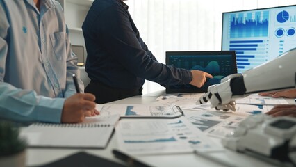 Poster - A dynamic workspace shows business professionals analyzing data on screens with advanced technology. The team discusses strategies and innovative solutions for business growth.Noogenesis