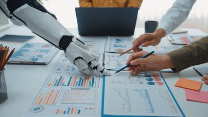 Poster - A futuristic scene depicting a collaboration between a human hand and a robotic arm over business reports, showcasing data analysis in a modern office environment.Noogenesis