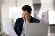 © fizkes - Businessman read document with shocked, distressed expression at workplace, facing serious issues, get terrible or troubling news in notice. Financial loss, contract termination or deal cancellation