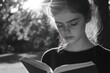 © Ifti Digital - Serious girl reading a book in a sunny park setting during the day, Serious girl reading a book in the park with sun reflections on her face