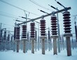 © miss irine - High voltage electrical substation insulators in snowy winter conditions. Power plant equipment for industrial energy distribution, electric transmission facilities, high power supply infrastructure.