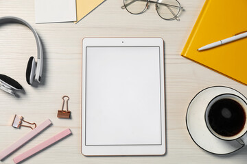 Poster - Tablet, different stationery, glasses, headphones and coffee on light wooden table, flat lay