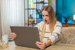 © Andrii Iemelianenko - Caucasian woman at home on table working on laptop, virus error, lost data, screen, tapping keys, feeling anxious, desperate, needing fix. Girl appears confused, frustrated, holding head, seeking help