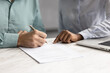 © fizkes - Close up view, man holding pen and signing lease or rental paper agreement, buying personal insurance coverage, committing to bank loan, credit line, or investment, accepting vendor or supplier terms