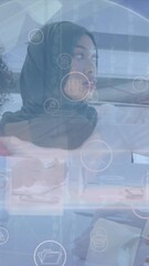 Poster - Animation of icons and globe over diverse businesswomen working in office