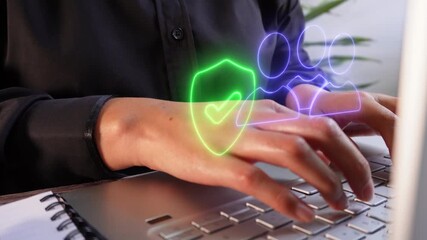 Poster - Close-up of a businesswoman's hands working on a computer with a glowing virtual icon of a group of people holding a shield.
