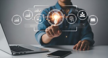 Poster - A person interacting with a digital interface with icons and a lightbulb on a desk with devices