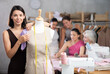 © JackF - Adult woman working with mannequin during sewing master class in workshop