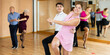 © JackF - Happy young girl and guy enjoying active lindy hop dance in modern studio. Social dancing concept