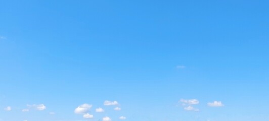 Wall Mural - Bright sky with white fluffy clouds in summer. Blue sky with clouds. Soft white clouds float in the clear blue sky. Clear blue sky, bright spring, wallpaper landscape.