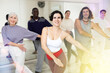 © JackF - Group of dancing people practicing energetic swing during a class in a dance studio